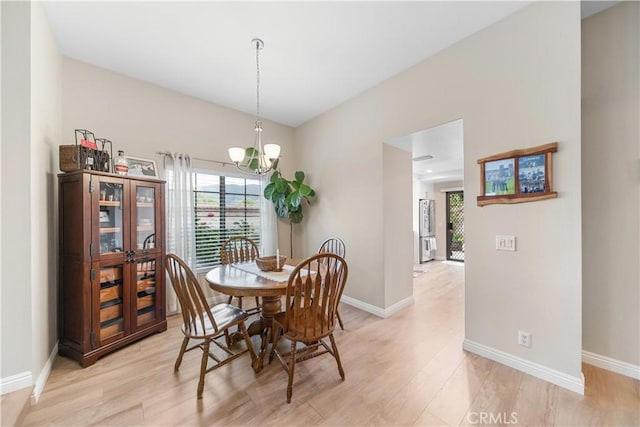 dining area featuring light wood-style floors, baseboards, and plenty of natural light