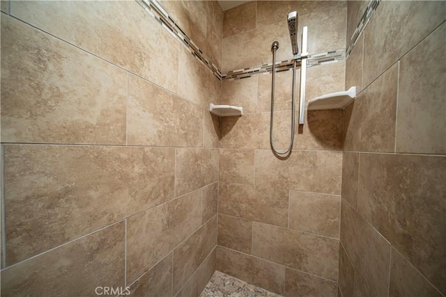 interior details with a tile shower