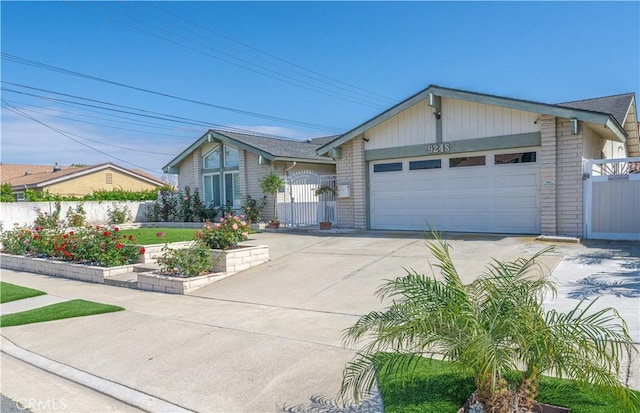 ranch-style home featuring a gate, concrete driveway, a garage, and fence