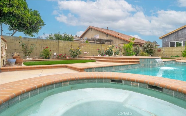 view of swimming pool with a fenced backyard and an in-ground hot tub