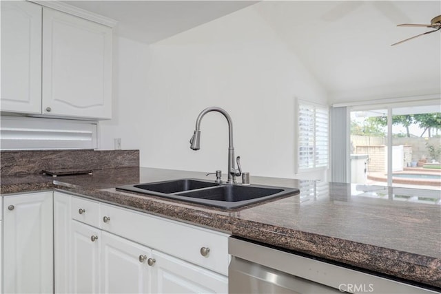 kitchen featuring dishwasher, a sink, a ceiling fan, white cabinets, and vaulted ceiling