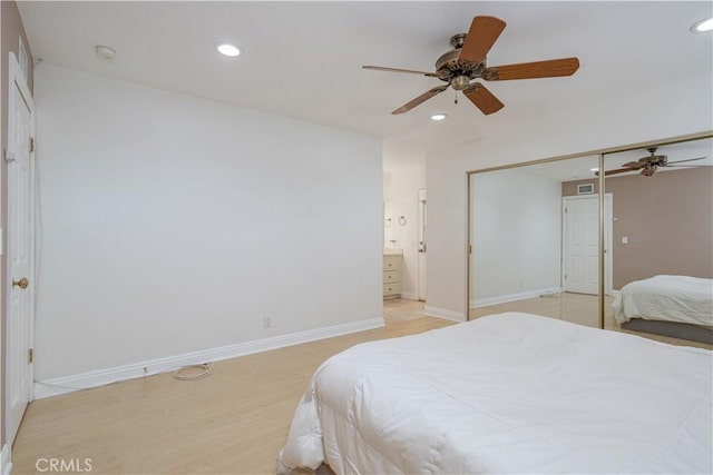 bedroom with recessed lighting, baseboards, connected bathroom, a ceiling fan, and a closet