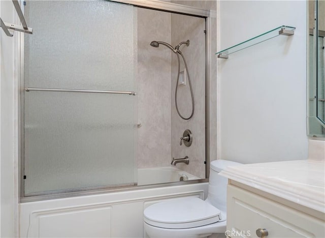 full bathroom featuring toilet, combined bath / shower with glass door, and vanity