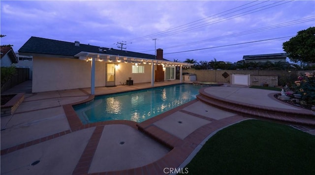 view of swimming pool with a patio area, a fenced backyard, and a pool with connected hot tub
