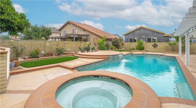 view of pool featuring a fenced backyard, a pool with connected hot tub, and a patio