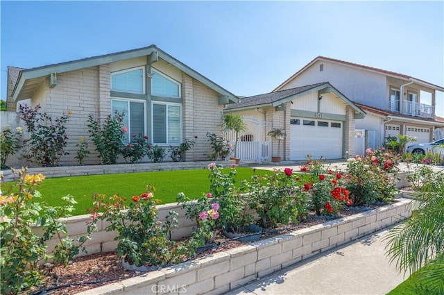 view of front of house featuring an attached garage and a front yard