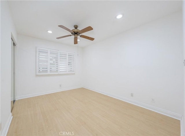 unfurnished room with light wood-style flooring, a ceiling fan, recessed lighting, and baseboards