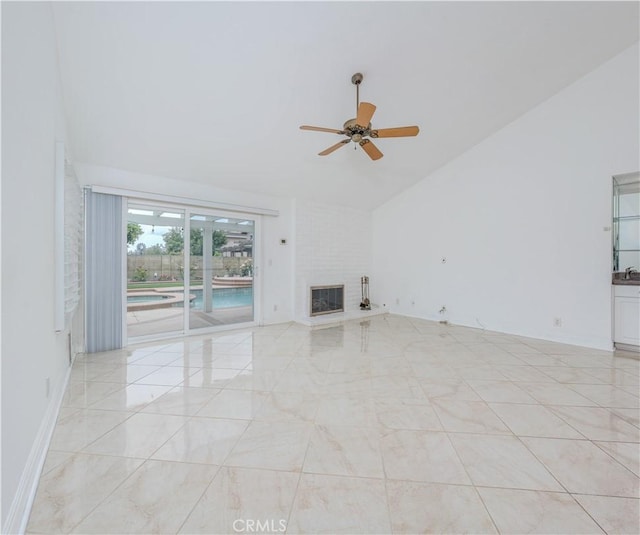 unfurnished living room featuring a ceiling fan, a fireplace, and high vaulted ceiling