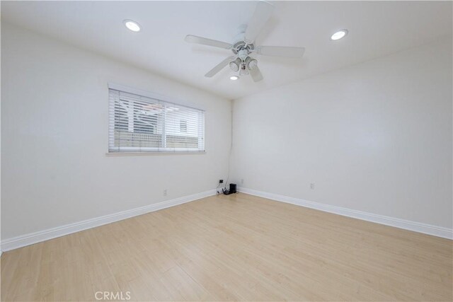 empty room featuring light wood-type flooring, baseboards, recessed lighting, and a ceiling fan