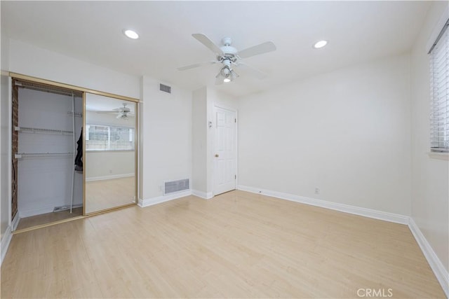 unfurnished bedroom featuring wood finished floors, recessed lighting, a closet, baseboards, and ceiling fan