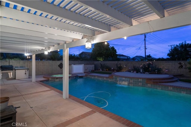 view of pool with a fenced backyard, a pool with connected hot tub, exterior kitchen, and a patio