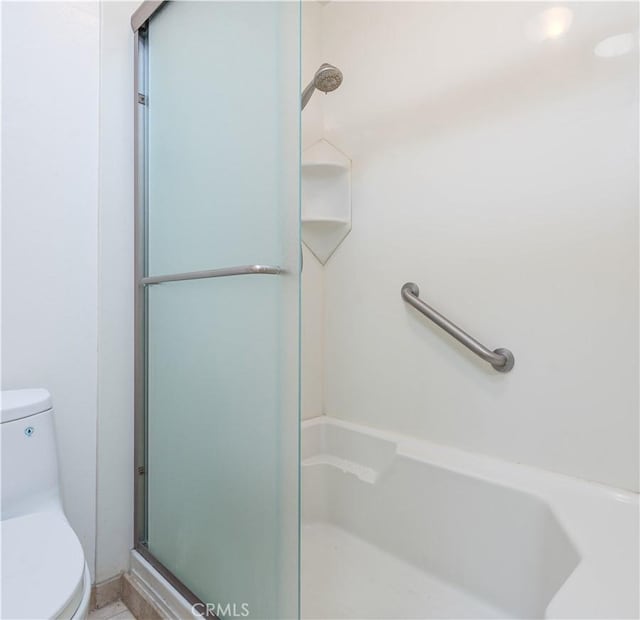 full bathroom featuring an enclosed shower and toilet