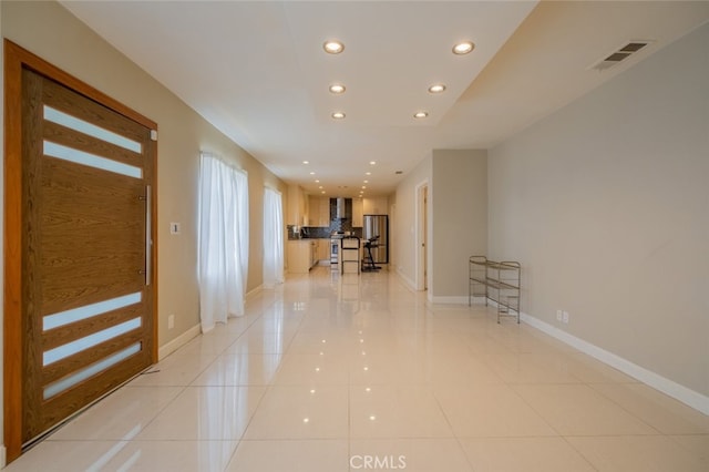 interior space featuring baseboards, recessed lighting, light tile patterned flooring, and visible vents