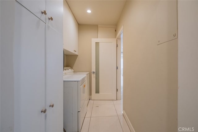 laundry room with light tile patterned flooring, baseboards, recessed lighting, separate washer and dryer, and cabinet space