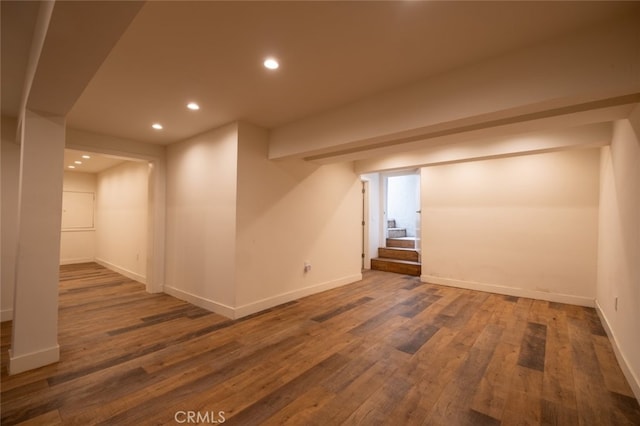 finished below grade area featuring baseboards, recessed lighting, and wood finished floors