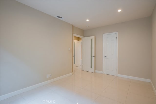 unfurnished bedroom featuring light tile patterned floors, baseboards, recessed lighting, and visible vents