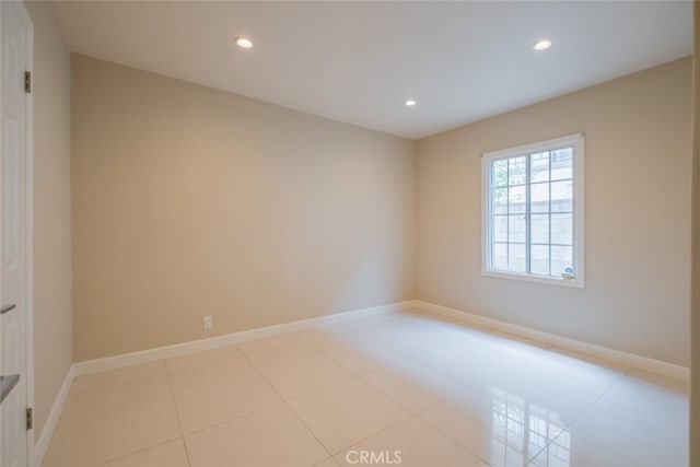 spare room with recessed lighting, baseboards, and light tile patterned floors