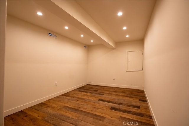 spare room featuring recessed lighting, baseboards, and wood finished floors