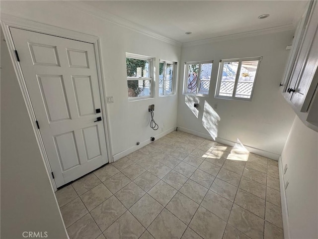 entrance foyer featuring light tile patterned floors, ornamental molding, and a wealth of natural light