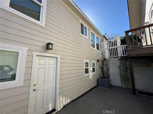 exterior space with a patio and cooling unit