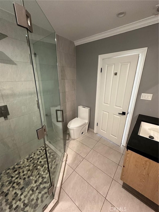 bathroom featuring crown molding, tile patterned flooring, vanity, toilet, and a stall shower