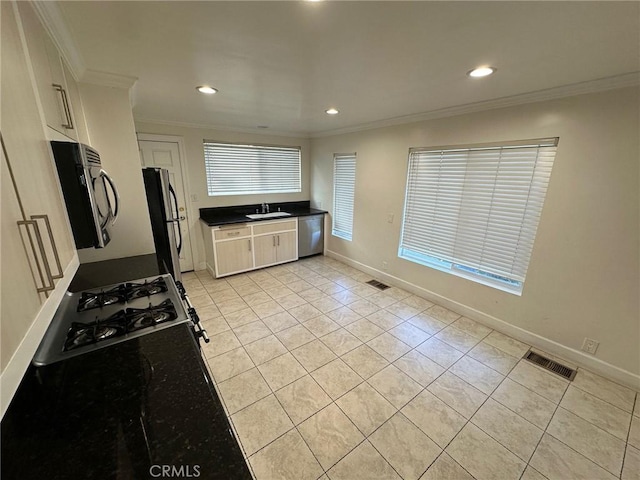 kitchen with stainless steel appliances, visible vents, a sink, and light tile patterned floors