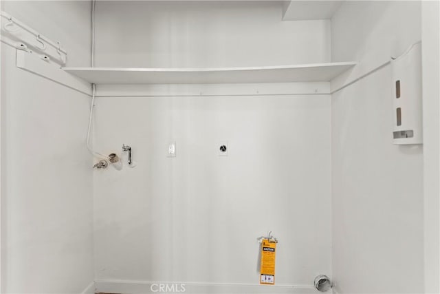 laundry room with baseboards, laundry area, and washer hookup