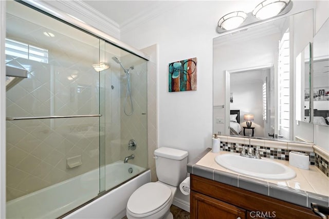 bathroom featuring crown molding, vanity, ensuite bath, toilet, and bath / shower combo with glass door
