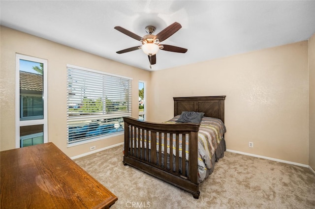 bedroom featuring baseboards, a ceiling fan, and carpet floors
