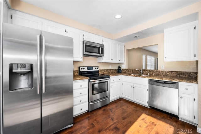 kitchen featuring dark wood-type flooring, a sink, white cabinetry, and stainless steel appliances