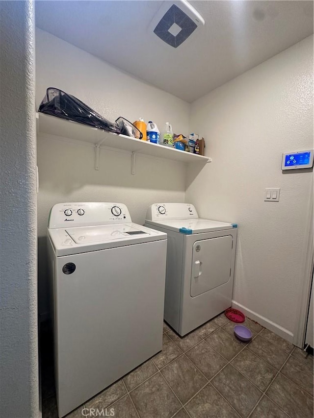 628 Marcus St, Merced, CA 95341 - clothes washing area featuring dark tile patterned floors, baseboards, laundry area, and washing machine and dryer