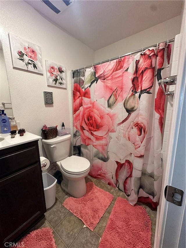 628 Marcus St, Merced, CA 95341 - bathroom featuring visible vents, curtained shower, vanity, tile patterned floors, and toilet