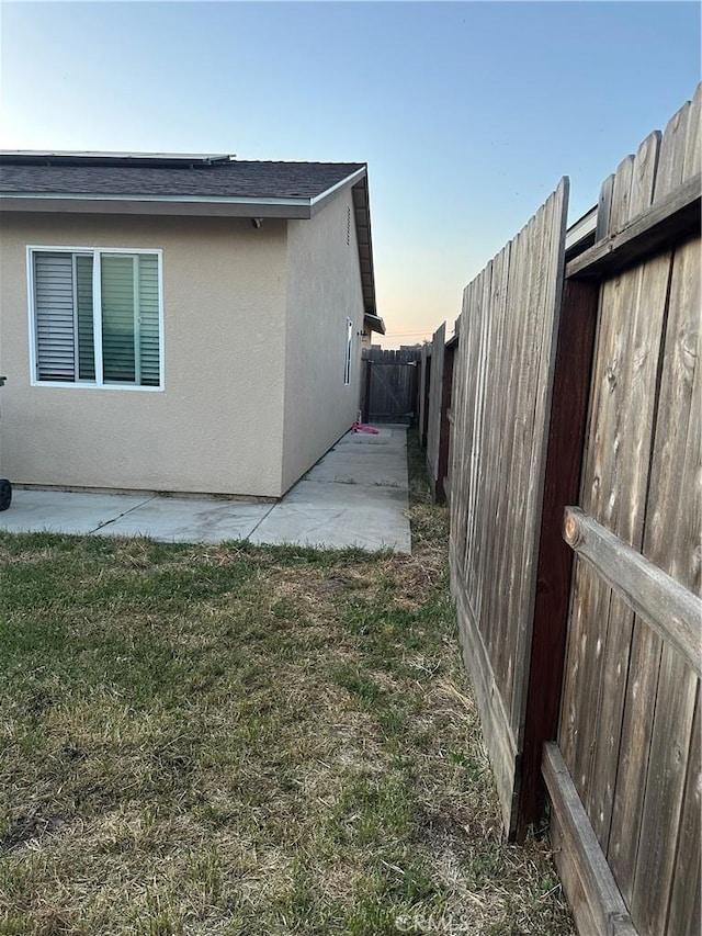 628 Marcus St, Merced, CA 95341 - view of home's exterior featuring a patio, a fenced backyard, a lawn, and stucco siding