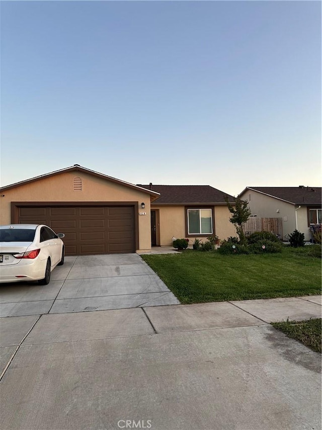 628 Marcus St, Merced, CA 95341 - single story home with a garage, stucco siding, concrete driveway, and a front yard