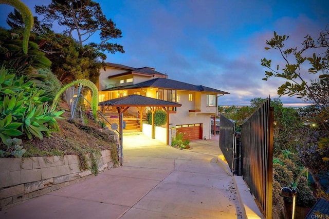 2525 Jackson St, San Diego, CA 92110 - view of front of property with stucco siding, driveway, an attached garage, and stairway