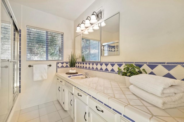 2525 Jackson St, San Diego, CA 92110 - bathroom with double vanity, a shower with door, tile patterned flooring, and plenty of natural light