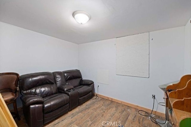 living room featuring baseboards and wood finished floors