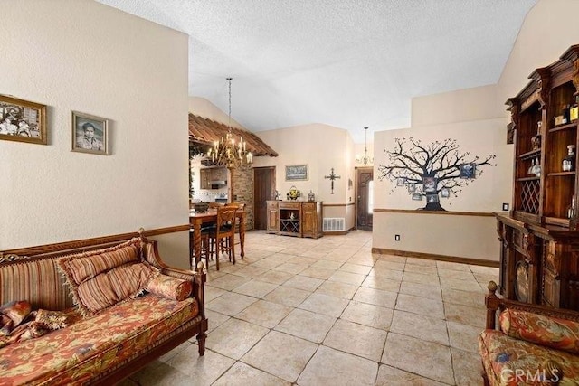 living area featuring a textured ceiling, light tile patterned floors, lofted ceiling, and a notable chandelier