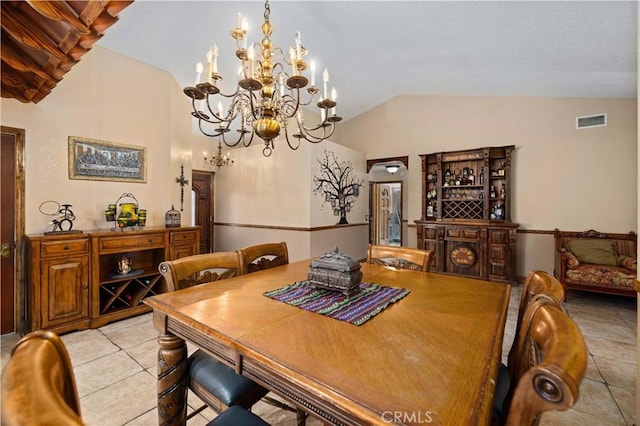 dining room with light tile patterned floors, an inviting chandelier, lofted ceiling, and visible vents
