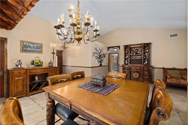 dining room with visible vents, light tile patterned floors, a chandelier, and vaulted ceiling