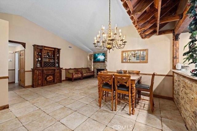 dining room with a stone fireplace, visible vents, vaulted ceiling, light tile patterned floors, and baseboards