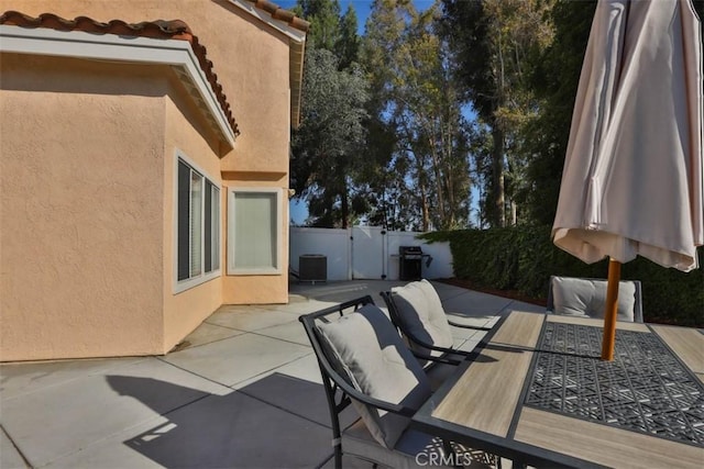 3514 Myers St Unit 15, Riverside, CA 92503 - fenced backyard featuring a patio, outdoor dining space, central air condition unit, and a gate