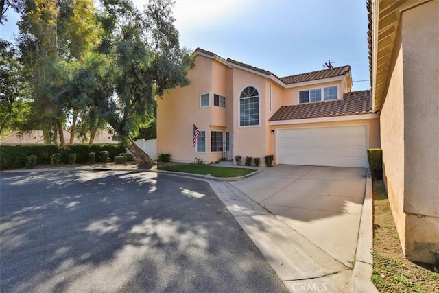 3514 Myers St Unit 15, Riverside, CA 92503 - view of front of house with a tile roof, stucco siding, driveway, and an attached garage