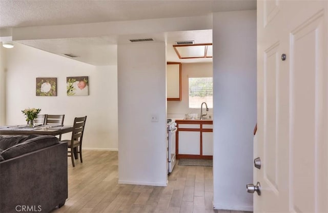 3514 Myers St Unit 15, Riverside, CA 92503 - kitchen with a sink, light wood-style floors, white range with electric stovetop, and baseboards