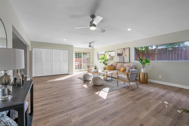 living room featuring baseboards, recessed lighting, ceiling fan, and wood finished floors