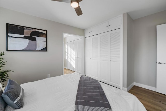 bedroom with light wood-type flooring, baseboards, ceiling fan, and a closet