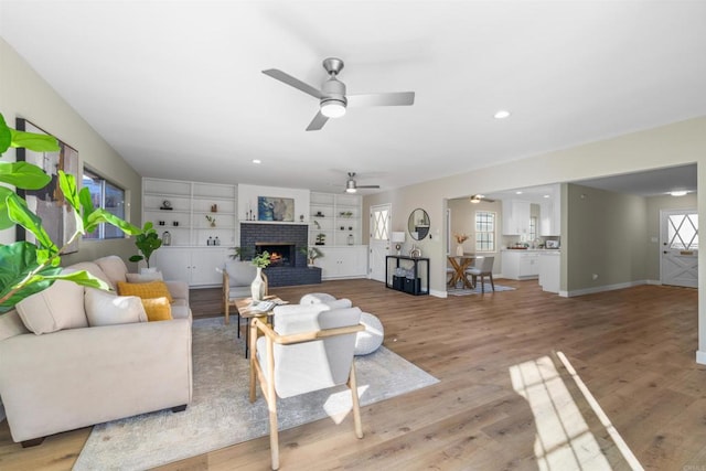 6662 Birchwood St, San Diego, CA 92120 - living area with a ceiling fan, a brick fireplace, light wood-type flooring, plenty of natural light, and recessed lighting