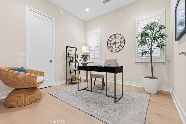 office space featuring recessed lighting, baseboards, and light wood-style floors