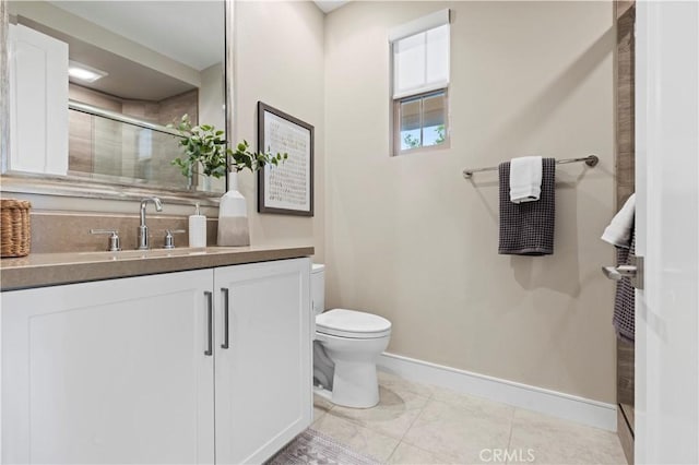 bathroom with an enclosed shower, toilet, baseboards, and vanity