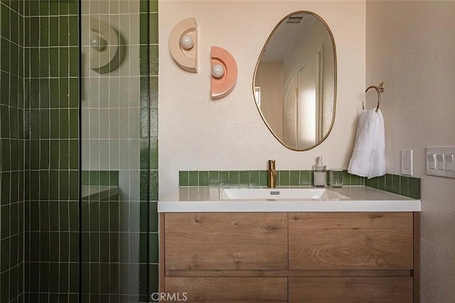 bathroom with vanity and tiled shower